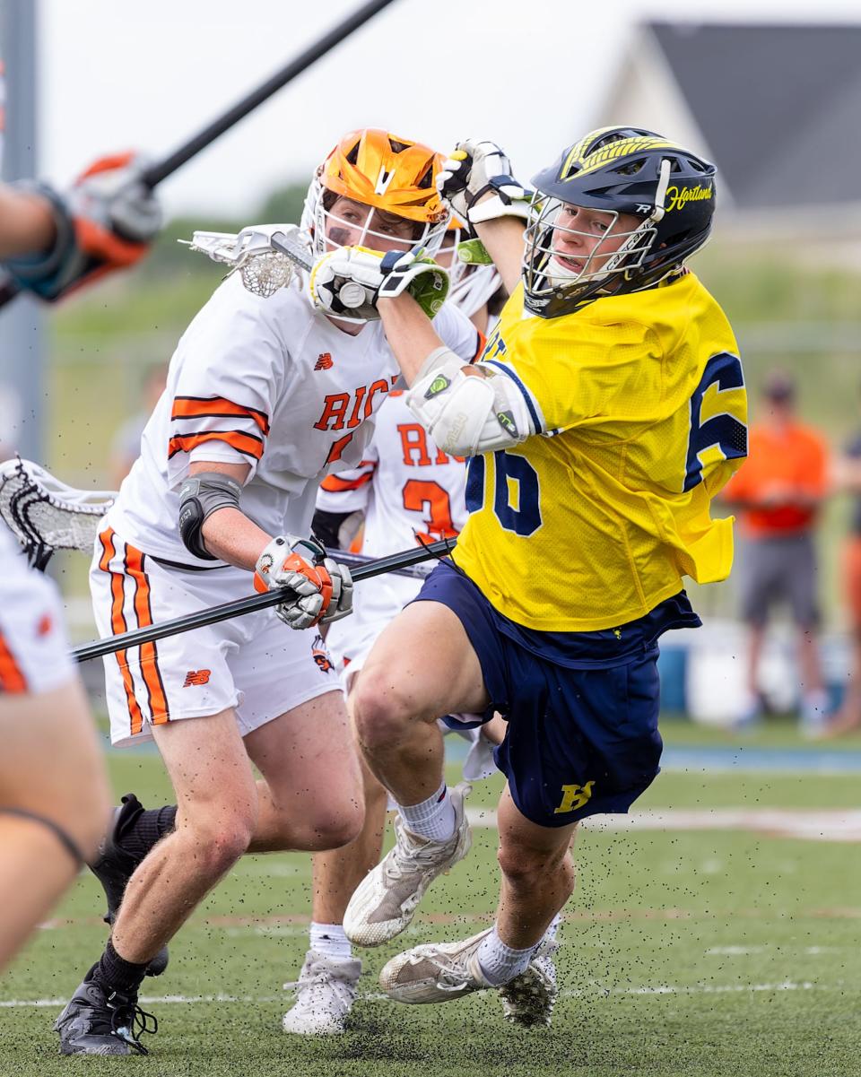 Hartland's Josh Wiater fights through traffic during an 11-10 overtime victory over Birmingham Brother Rice in the state Division 1 championship lacrosse game on Saturday, June 11, 2022.