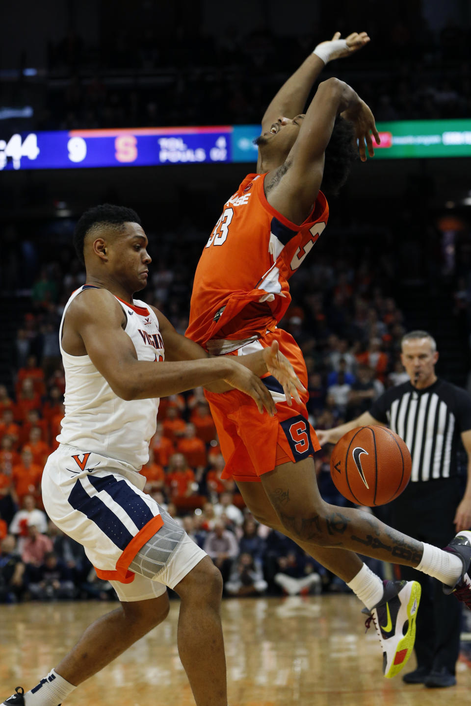 Syracuse forward Elijah Hughes (33) looses the ball as Virginia guard Casey Morsell (13) defends during the first half of an NCAA college basketball game in Charlottesville, Va., Saturday, Jan. 11, 2020. Morsell ws called for a four on the play. (AP Photo/Steve Helber)