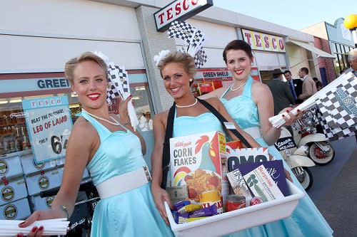 Assistants outside a 1960s store recreated by supermarket giant Tesco at this weekend's Goodwood Revival historic motor race meeting (Tesco/PA)