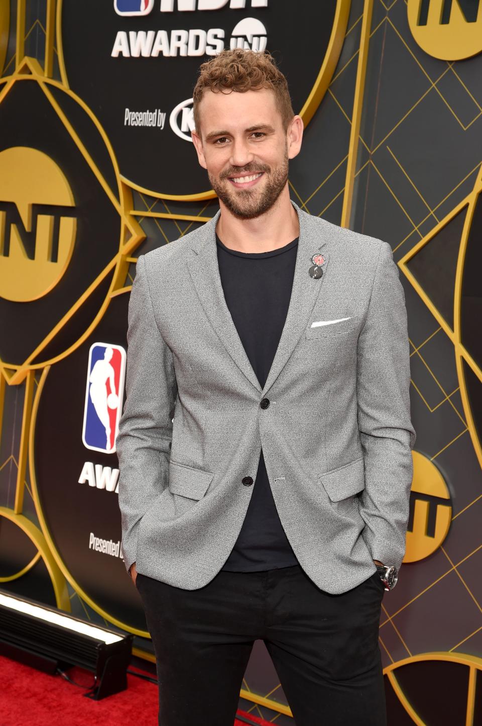 Nick Viall rocks a grey suit and black pant, and he looks incredible