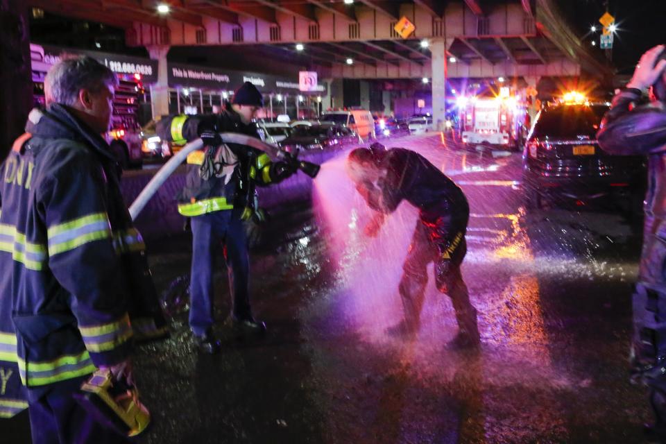 <em>A FDNY diver is sprayed with water after attending the incident (Getty Images)</em>