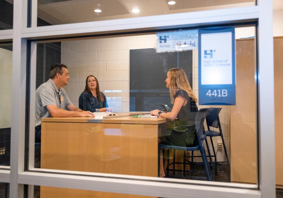 Scott Bakkum, a mental health navigator; Allison Beyerl (center), director of learning-psych; and Rebecca Ladsten, director of High School of Health Sciences use one of the resource centers on the Kettle Moraine High School campus. The centers have been implemented as part of the school district's youth mental health initiative, which also includes new staff training tools, student resources, quiet areas in classrooms, counseling spaces and more.