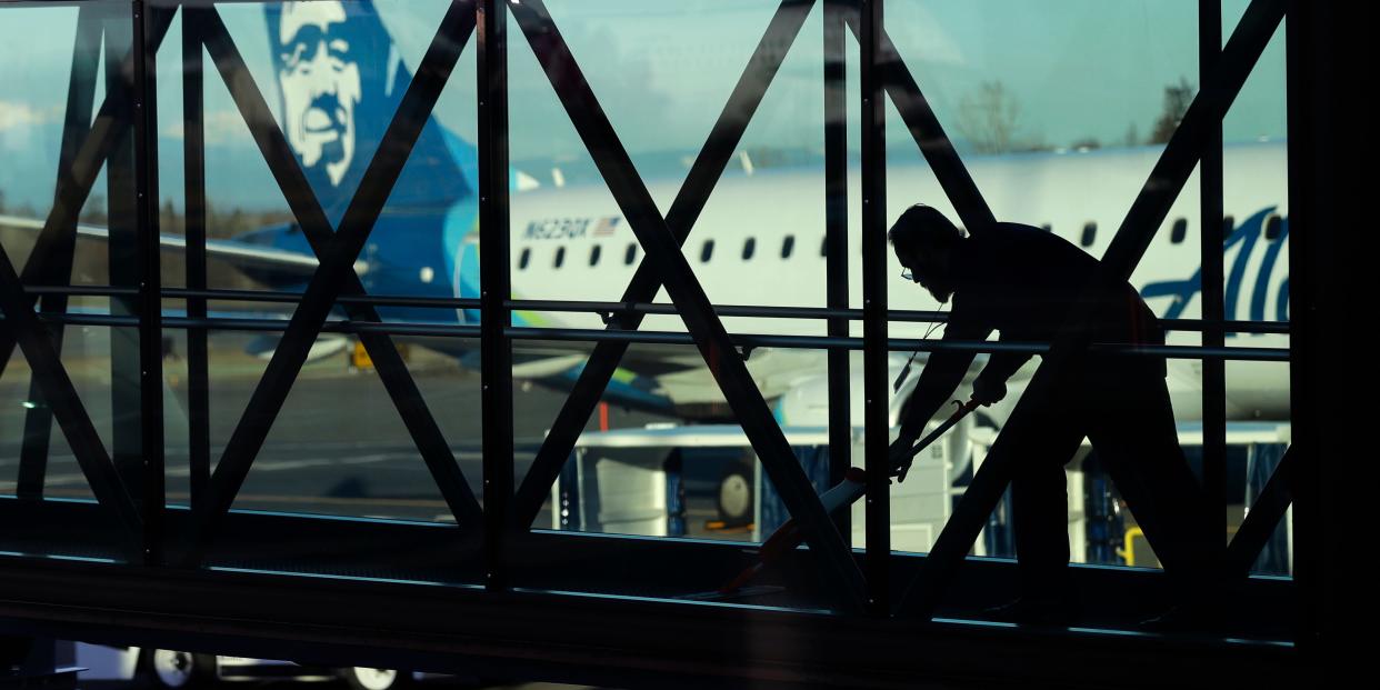 FILE- In this March 4, 2019, file photo a worker cleans a jet bridge before passengers boarded an Alaska Airlines flight to Portland, Ore., at Paine Field in Everett, Wash. On Friday, March 8, the U.S. government issues the February jobs report, which will reveal the latest unemployment rate and number of jobs U.S. employers added. (AP Photo/Ted S. Warren, File)