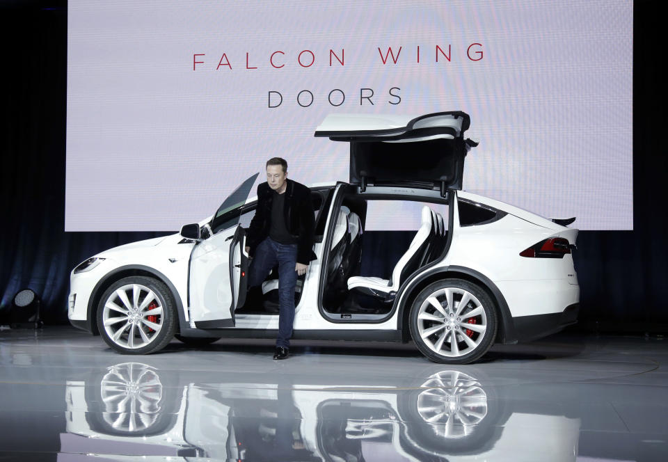 FTSE  Elon Musk, CEO of Tesla Motors Inc., introduces the Model X car at the company's headquarters Tuesday, Sept. 29, 2015, in Fremont, Calif. Musk said the Model X sets a new bar for automotive engineering, with unique features like rear falcon-wing doors, which open upward, and a driver's door that opens on approach and closes itself when the driver is inside. (AP Photo/Marcio Jose Sanchez)