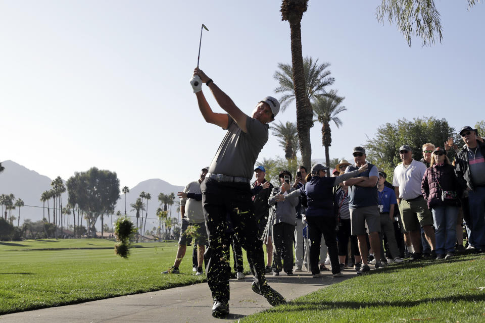 Phil Mickelson hits from the rough on the fourth hole during the first round of The American Express golf tournament at La Quinta Country Club Thursday, Jan. 16, 2020, in La Quinta, Calif. (AP Photo/Marcio Jose Sanchez)