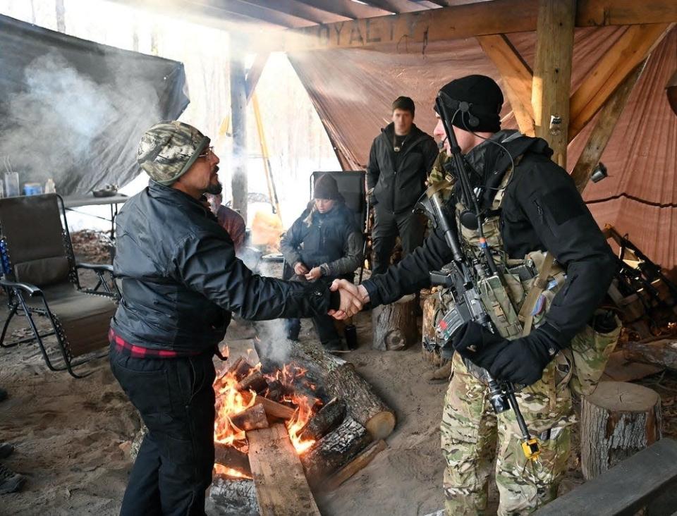 A Special Forces candidate assigned to the John F. Kennedy Special Warfare Center and School meets with the &quot;G Chief,&quot; a role-player acting as a village leader Jan. 23, 2022, in central North Carolina during the final phase of field training known as Robin Sage.