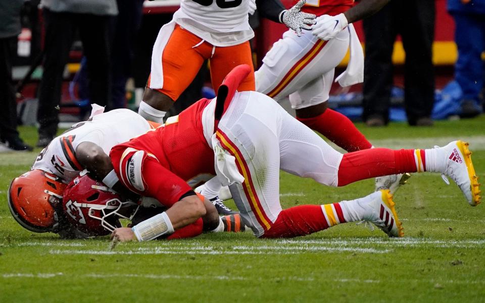 Kansas City Chiefs quarterback Patrick Mahomes (15) is brought down by Cleveland Browns outside linebacker Mack Wilson (51) during the second half in the AFC Divisional Round playoff game at Arrowhead Stadium. - Jay Biggerstaff-USA TODAY Sports