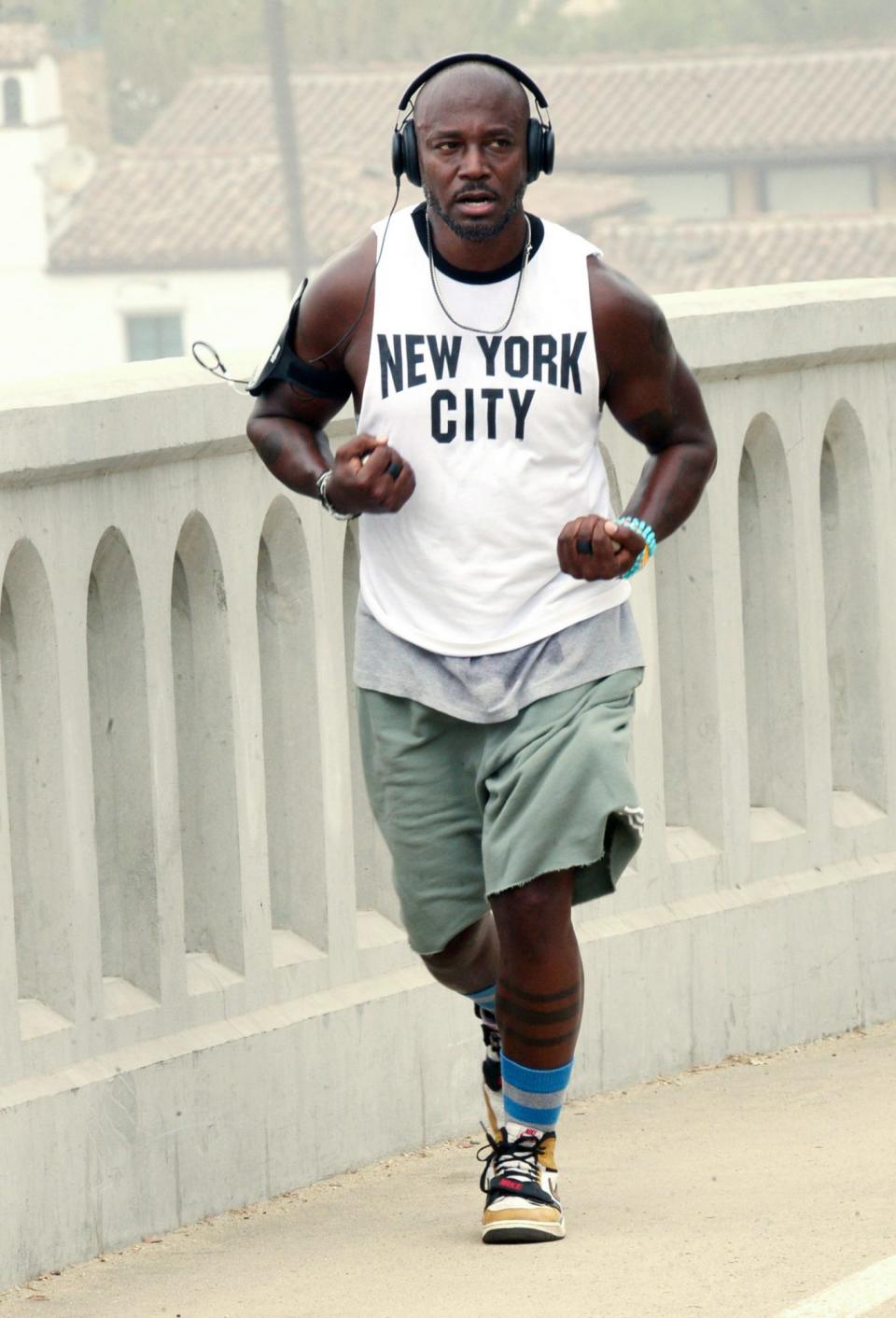 <p>Taye Diggs wears a ‘New York City’ tank top while out for a run on Wednesday in Santa Monica. </p>