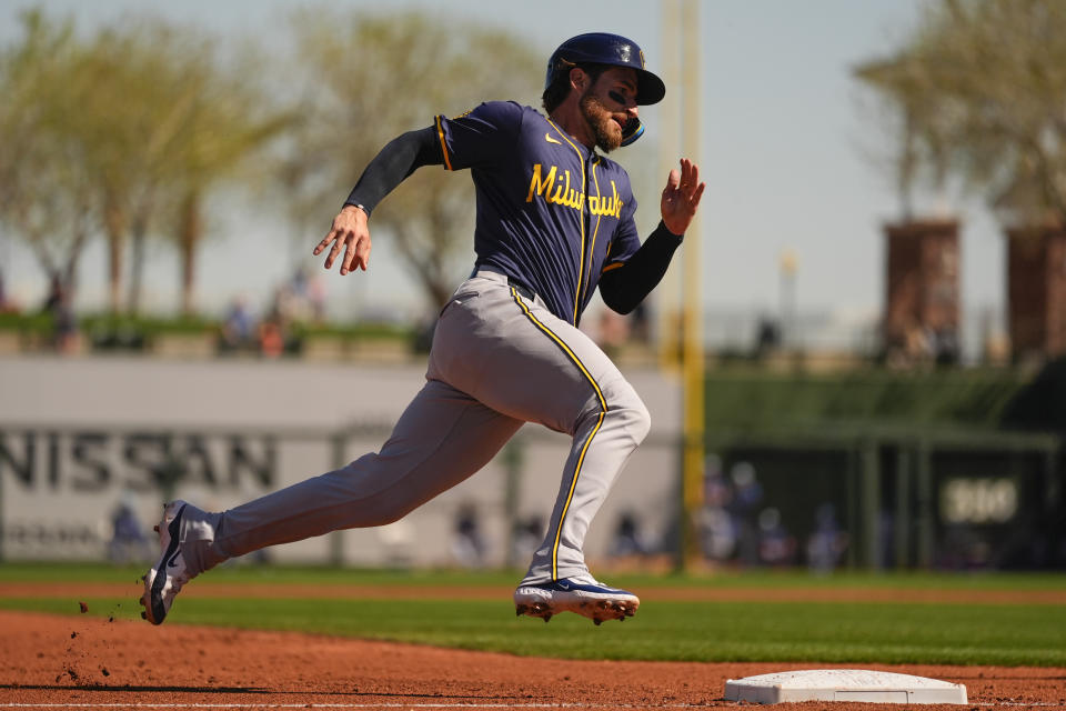 Milwaukee Brewers' Eric Haase rounds third base to score on an RBI double by Brock Wilken against the Texas Rangers during the third inning of a spring training baseball game Thursday, Feb. 29, 2024, in Surprise, Ariz. (AP Photo/Lindsey Wasson)