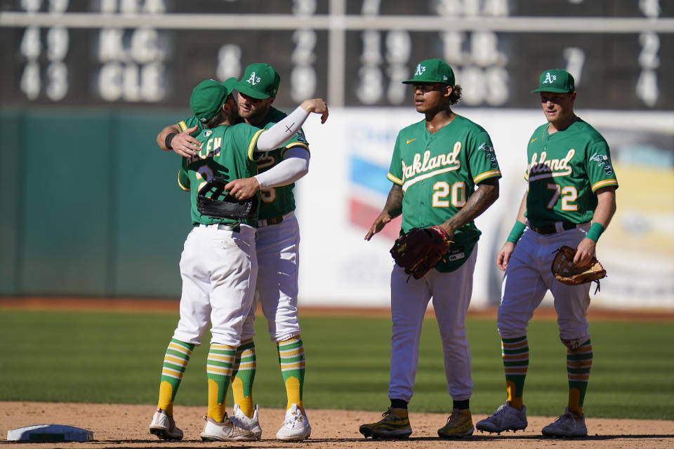 Oakland Athletics' Nick Allen (2) hugs Seth Brown after the team's 3-2 victory over the Los Angeles Angels in a baseball game in Oakland, Calif., Wednesday, Oct. 5, 2022. (AP Photo/Godofredo A. Vásquez)