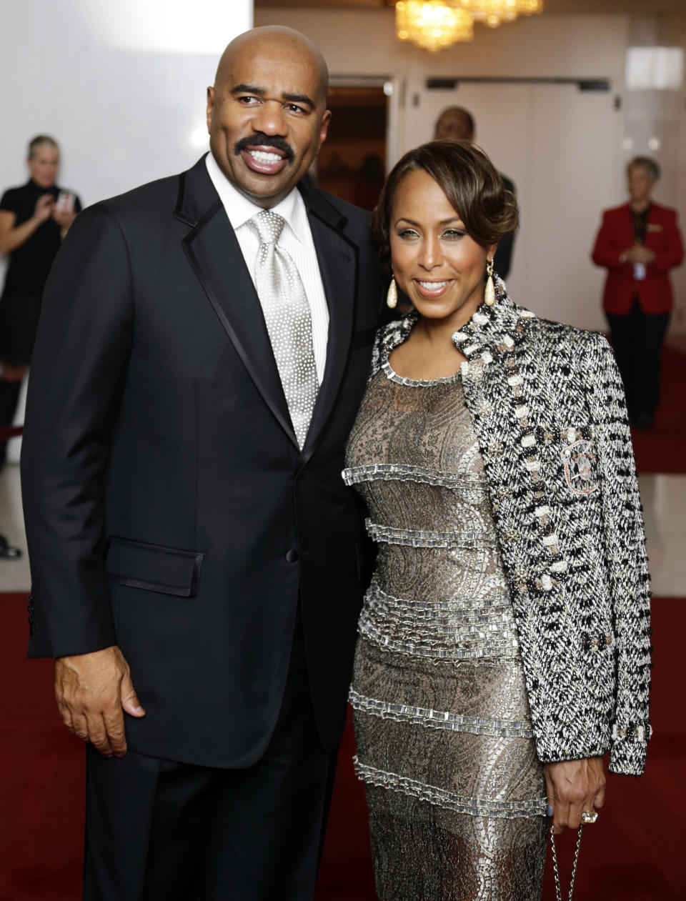 Entertainer Steve Harvey, left, with his wife Marjorie Bridges pose for photographers on the red carpet before entertainer Ellen DeGeneres receives the 15th annual Mark Twain Prize for American Humor at the Kennedy Center, Monday, Oct. 22, 2012, in Washington. (AP Photo/Alex Brandon)