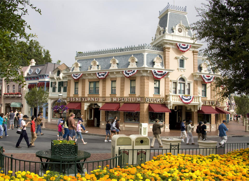 This undated image released by Disney theme parks shows guests on Main Street U.S.A. at the Disneyland theme park in Anaheim, Calif. A pair of childhood friends rekindling memories by visiting the park as adults, Solvej Schou and Joanna Sondheim, found Main Street’s old-fashioned ambience a comforting alternative to tech-heavy modern life. (AP Photo/Disneyland, Paul Hiffmeyer)
