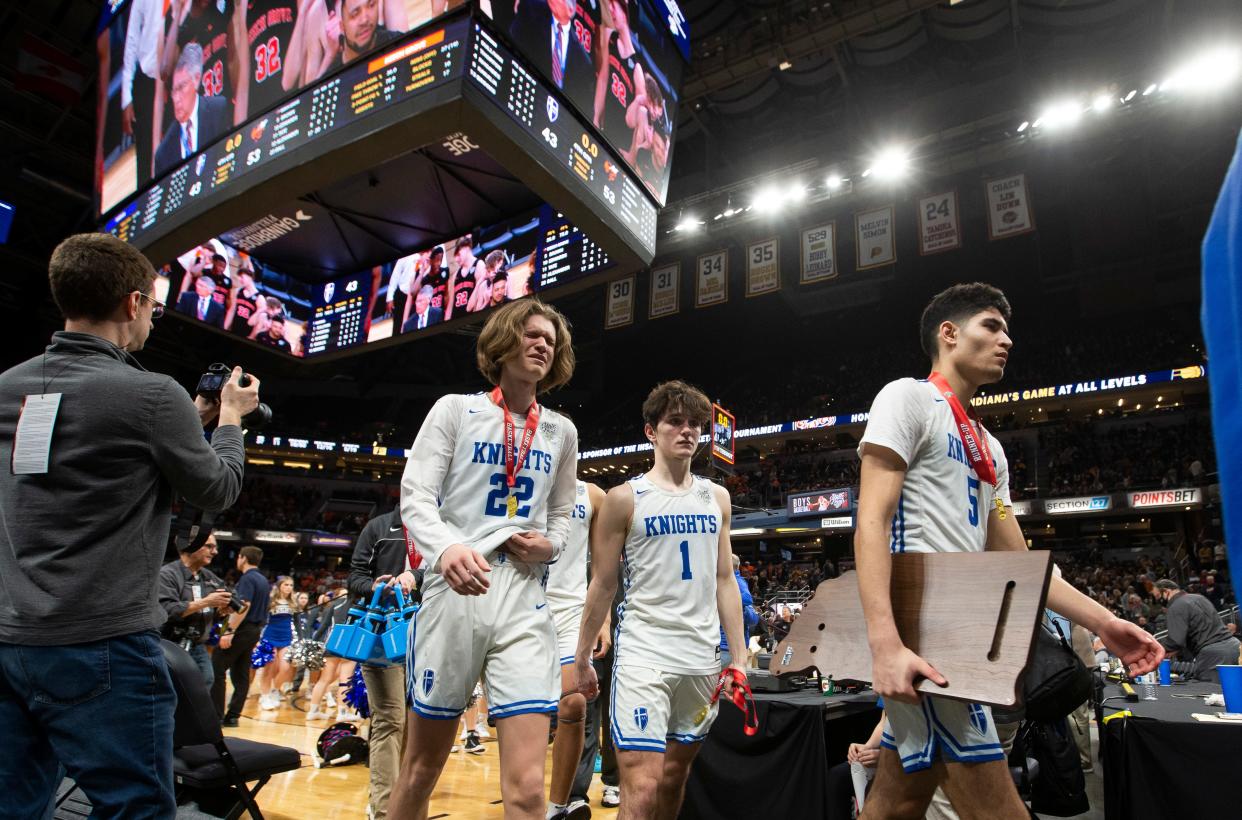 Players exit the court following Marian's loss to Beech Grove in the 3A boys basketball state championship game on Saturday, March 26, 2022, at Gainbridge Fieldhouse in Indianapolis. 