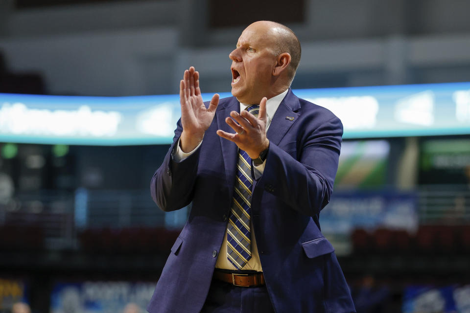 Northern Arizona head coach Shane Burcar cheers on his defense against Montana State in the first half of an NCAA college basketball game for the championship of the Big Sky men's tournament in Boise, Idaho, Wednesday, March 8, 2023. (AP Photo/Steve Conner)