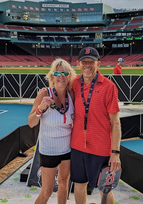 Framingham's Janice Aucoin of Framingham poses with her playing partner, Clint Berge of Natick, at the Pickle4 Ballpark Series Tournament at Fenway Park on July 14.
