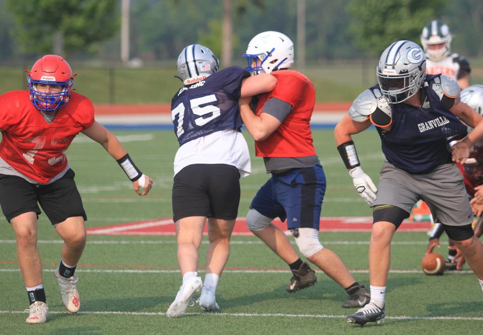 Lakewood center Stewart Poulnott blocks Granville defensive lineman Nick Purdy last week during Licking County practice at Lakewood's Calhoun Memorial Stadium for its all-star game Friday with Muskingum Valley.