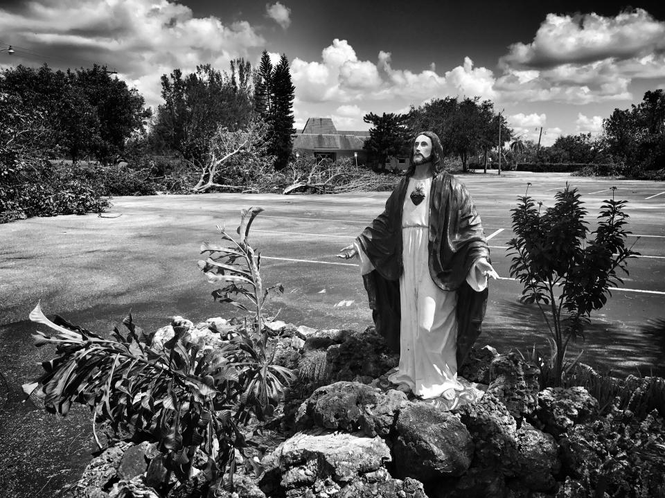 <p>A statue of Jesus stands amid storm debris from Hurricane Irma in Lehigh Acres, Fla. (Photo: Holly Bailey/Yahoo News) </p>