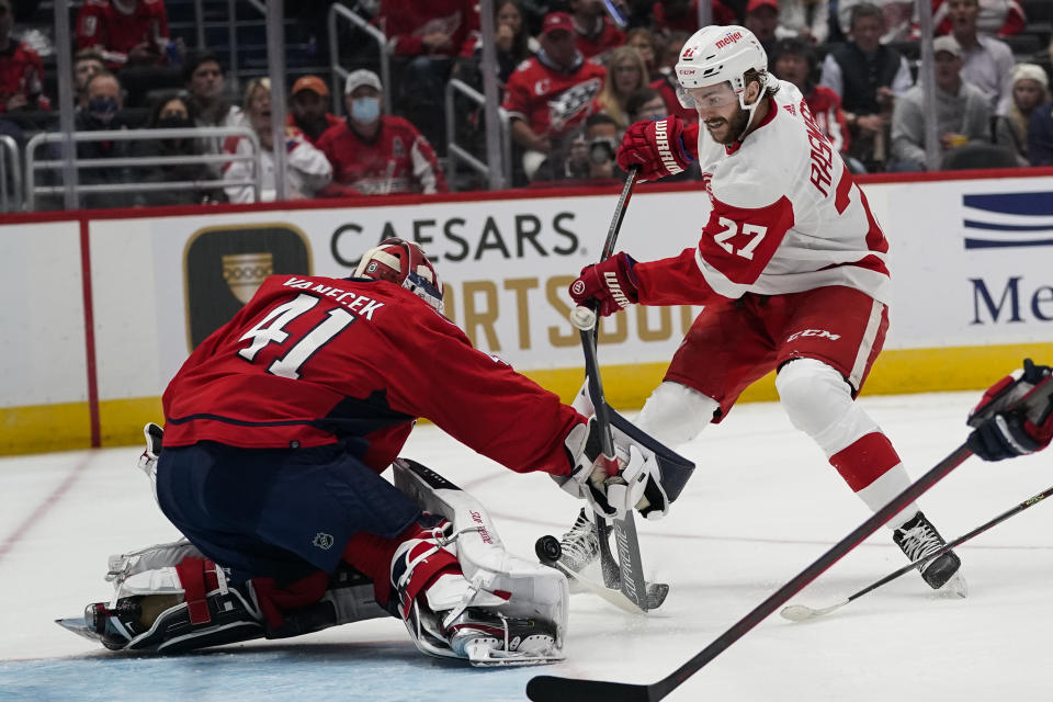 Washington Capitals goaltender Vitek Vanecek (41) blocks a shot by Detroit Red Wings center Michael Rasmussen (27) in the first period of an NHL hockey game, Wednesday, Oct. 27, 2021, in Washington. (AP Photo/Alex Brandon)