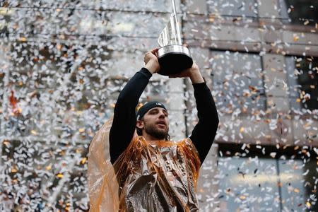 San Francisco Giants starting pitcher Madison Bumgarner (40) holds up his MVP trophy during the World Series victory parade on Market Street. Kelley L Cox-USA TODAY Sports