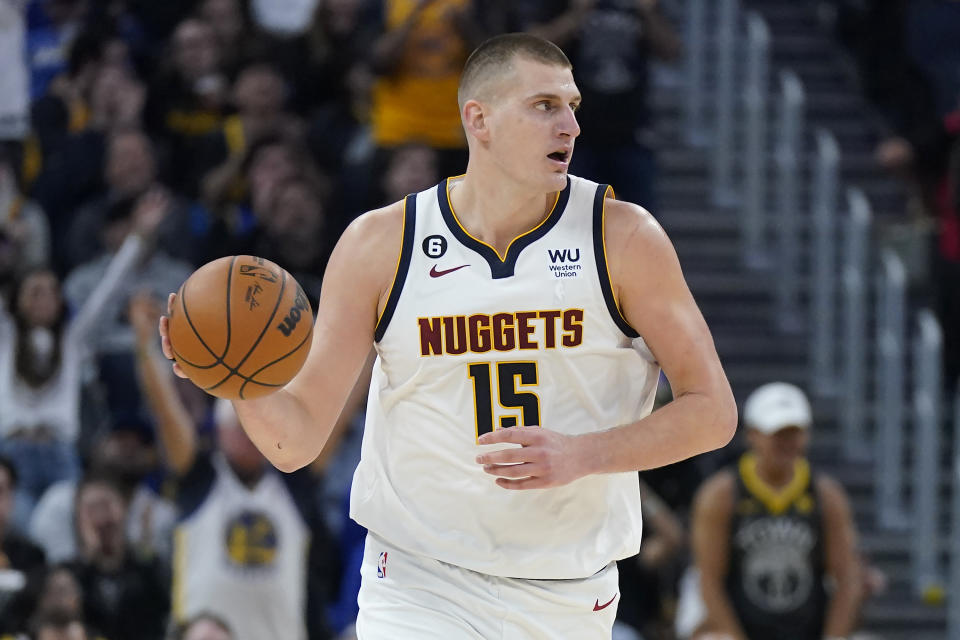 Denver Nuggets center Nikola Jokic brings the ball upcourt against the Golden State Warriors during the first half of an NBA basketball game in San Francisco, Friday, Oct. 21, 2022. (AP Photo/Jeff Chiu)