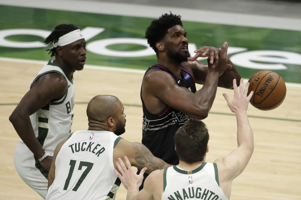 Philadelphia 76ers' Joel Embiid is fouled by Milwaukee Bucks' P.J. Tucker (17) during the second half of an NBA basketball game Thursday, April 22, 2021, in Milwaukee. (AP Photo/Aaron Gash)