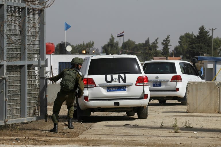 An Israeli soldier opens the only crossing point between Syria and Israeli-annexed Golan Heights near Quneitra, 2018, four years after its closure