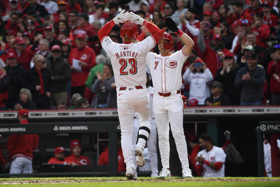 Cincinnati Reds's Nick Martini (23) is congratulations by Spencer Steer (7) following his two-run home run during the second inning of an opening day baseball game against the Washington Nationals in Cincinnati, Thursday, March 28, 2024. (AP Photo/Timothy D. Easley)