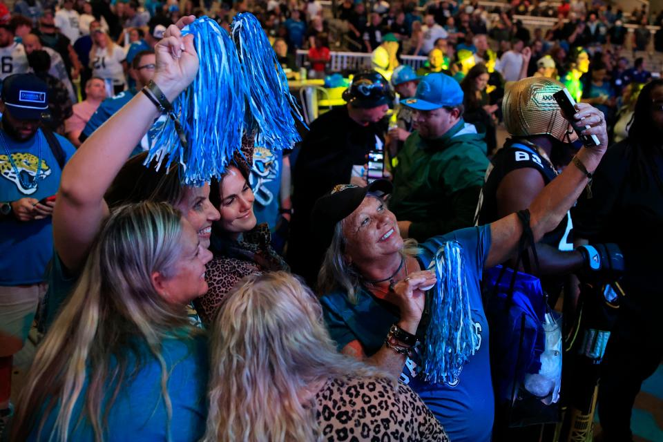 Jaguars fans Lori Allen talks a selfie with her friends during the 2023 NFL draft watch party.