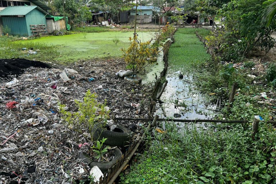 A photo, taken on October 11, 2023 shows plastic waste clogging waterways in Yangon’s Shwe Pyi Thar township. The build-up of plastic makes the water dark and dirty, residents said, and exacerbates monsoon flooding (AFP via Getty Images)
