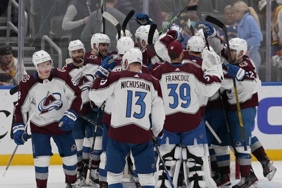 Members of Colorado Avalanche celebrate after defeating the St. Louis Blues in Game 6 of an NHL hockey Stanley Cup second-round playoff series Friday, May 27, 2022, in St. Louis. The Avalanche won the game to take the series 4-2. (AP Photo/Jeff Roberson)