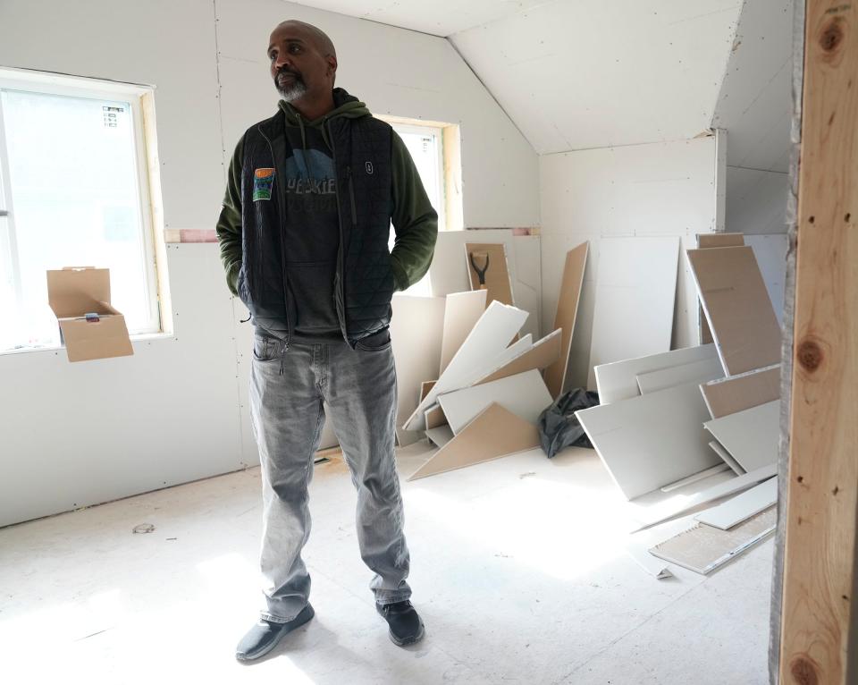 Walnut Way executive director Antonio Butts stands inside a home where work is being done to complete a sustainable, solar-powered house on North 15th Street in Milwaukee. The home is being updated and remodeled by Walnut Way Conservation Corp. in partnership with the City of Milwaukee.