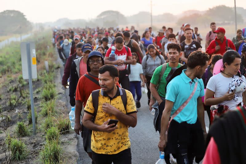 Migrants walk in a caravan as an attempt to reach the U.S. border, in Arriaga