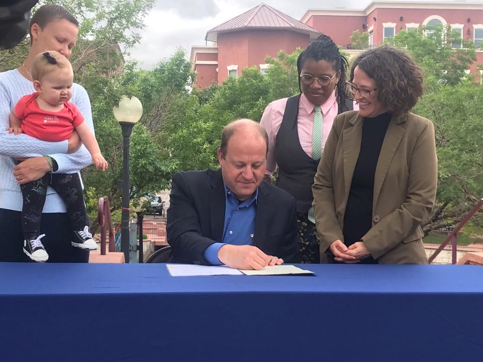 Colorado Gov. Jared Polis signs Marlo's Law at Pueblo City Hall on Monday in Pueblo, Colo.