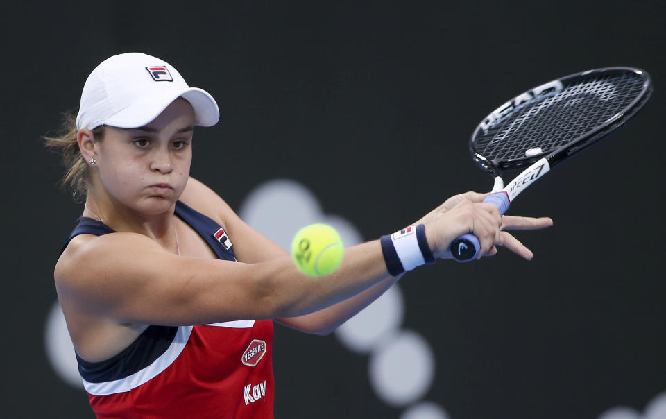 FILE - In this Jan. 10, 2019, file photo, Ash Barty of Australia hits a backhand to Elise Mertens of Belgium during their women's singles match at the Sydney International tennis tournament in Sydney. The world No. 1-ranked Barty on Thursday, Jan. 21, 2021, said she'll play in a one-day exhibition event in Adelaide on Jan. 29 which includes Serena Williams, Naomi Osaka and Simona Halep. (AP Photo/Rick Rycroft, File)