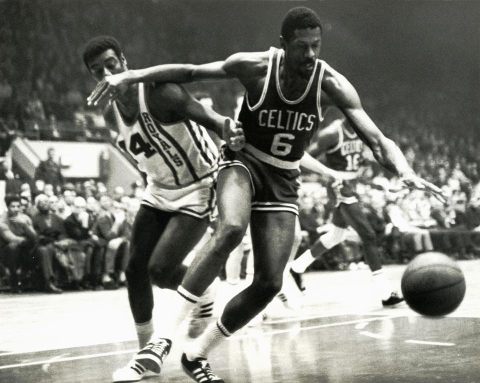 Boston Celtics center Bill Russell (6) fights for a loose ball against Cincinnati Royals guard Oscar Robertson (14) at Cincinnati Gardens. The alma maters of the two Hall of Famers play Wednesday night in the NIT as the Big O's Bearcats take on the San Francisco Dons where Russell starred.