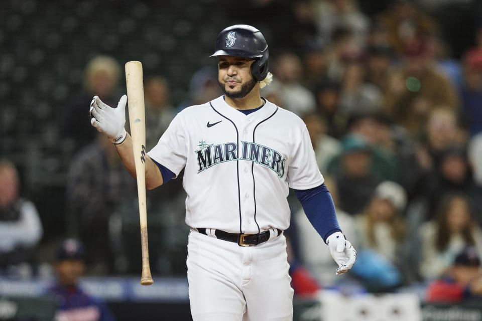 Seattle Mariners' Eugenio Suarez strikes out against the Minnesota Twins during the eighth inning a baseball game, Monday, June 13, 2022, in Seattle. The Twins won 3-2. (AP Photo/John Froschauer)