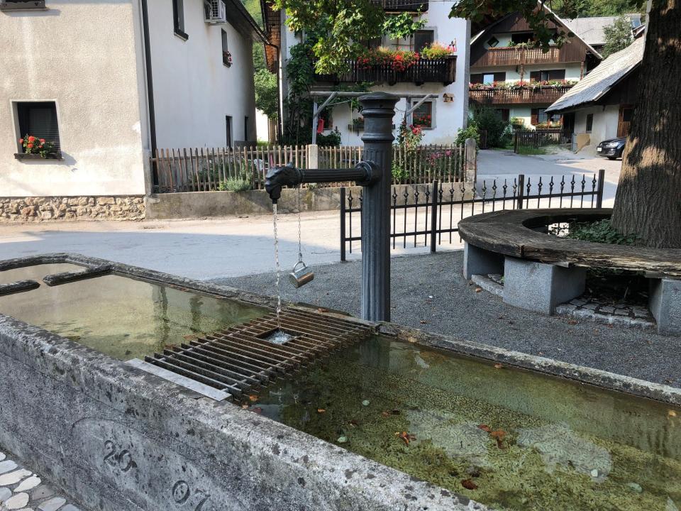 public water fountain with cup attached