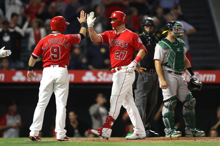 ANAHEIM, CALIFORNIA - JUNE 06: Tommy La Stella #9 congratulates Mike Trout #27 of the Los Angeles Angels of Anaheim.