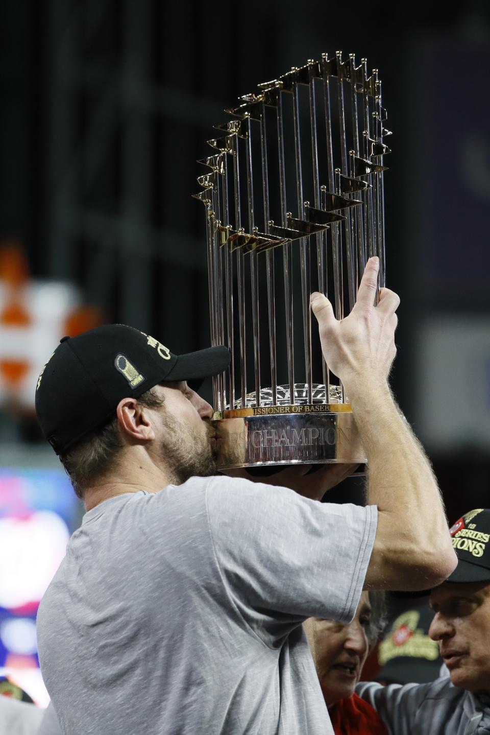FILE - In this Oct. 30, 2019, file photo, Washington Nationals' Max Scherzer celebrates after Game 7 of the baseball World Series against the Houston Astros in Houston. The last time these teams played the Nationals were celebrating their World Series title in Houston. Since then the Astros have become the league's villains, with a sign-stealing scandal tarnishing their reputation and casting a shadow on their 2017 title. (AP Photo/Matt Slocum, File)
