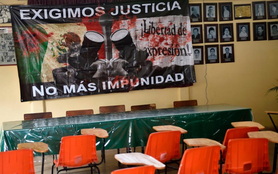A sign reading "We demand justice. No more impunity" hangs at the journalists' union office in Chilpancingo, Guerrero state - Credit: PEDRO PARDO/AFP