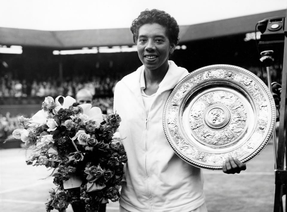 Althea Gibson holds her trophy after winning at Wimbledon on July 5, 1958. (Photo: AFP via Getty Images)