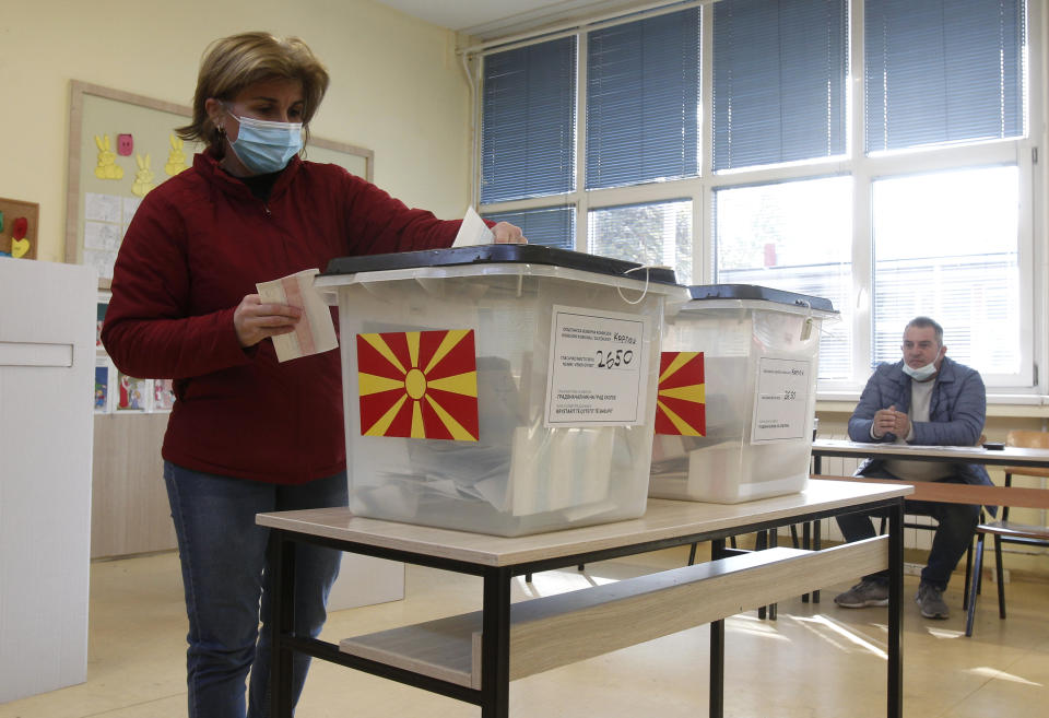 A woman casts her ballot at a polling station in Skopje, North Macedonia, on Sunday, Oct. 31, 2021. North Macedonia is holding a runoff of local elections on Sunday seen as key test for the leftist government after center-right opposition has won mayoral posts in 21 municipalities compared with only nine of ruling Social-democrats in the first round of the vote two weeks ago. (AP Photo/Boris Grdanoski)
