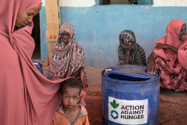 Women and children wait at the Dabafayed Resettlement project intended to become a new, permanent home for once-nomadic herders made destitute by the country's back-to-back droughts