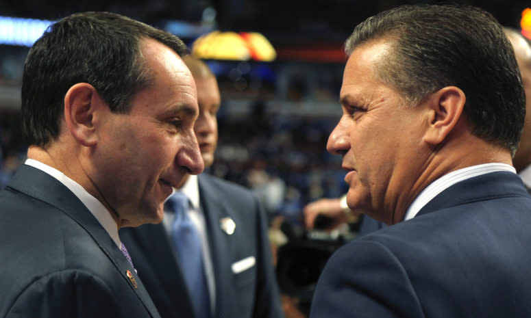 Coach K and Coach Cal chatting at a game.