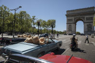 Teddy bears, set up by Philippe Labourel, who wants to be named 'Le papa des nounours' (Teddy Bears father) are pictured inside American vintage cars driving through Paris, Sunday, June, 13, 2021. The event took place in a show of support for the tourism industry which was hit by the COVID-19 pandemic. (AP Photo/Lewis Joly)