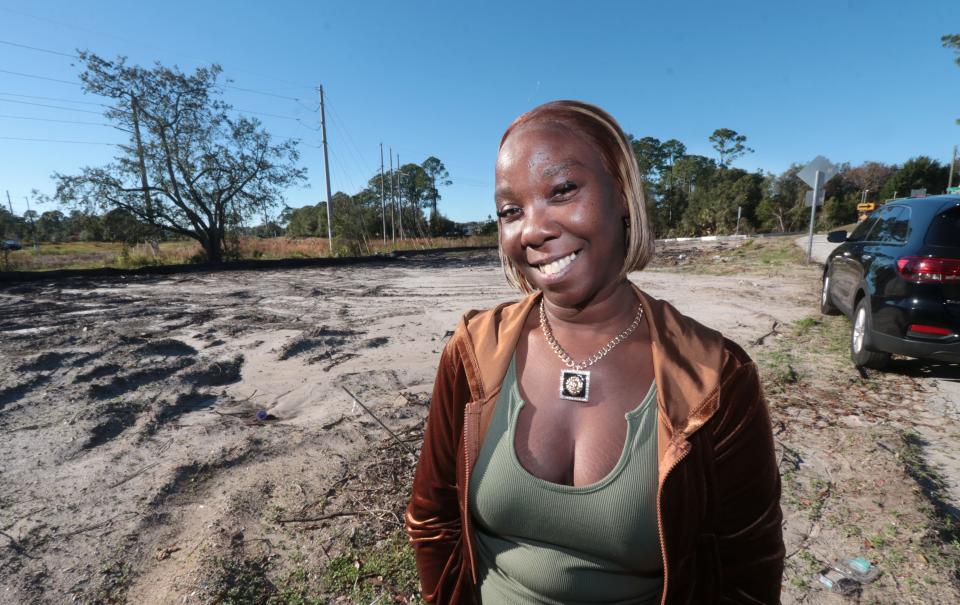 Lillie Lovett smiles in front of the empty lot that will be the site of her family's new home. Lovett, a healthcare worker, is among the Volusia County residents receiving support on the path to home ownership from the nonprofit Homes Bring Hope.