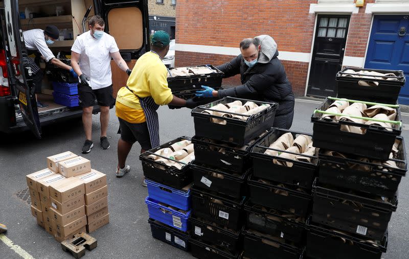 Staff of Annabel's private members club load meals for NHS workers into vans after they were prepared at their premises in London