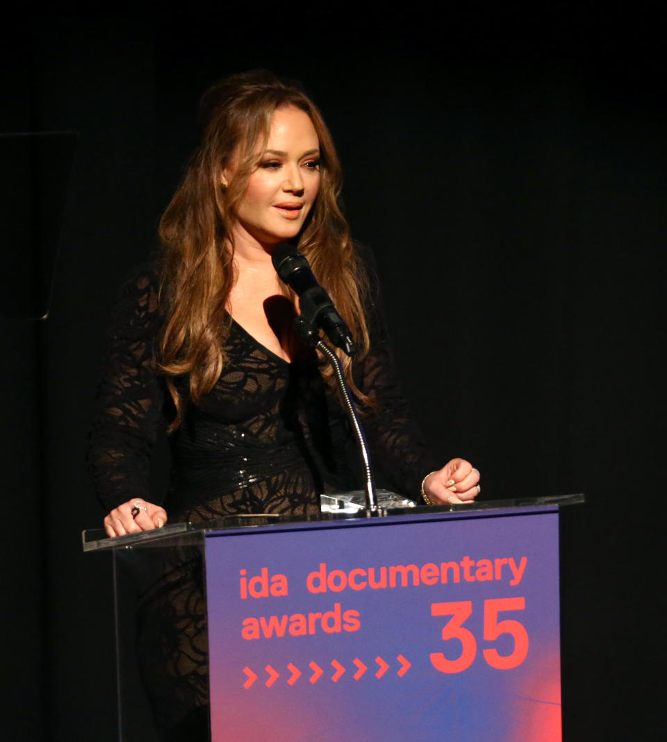 Leah Remini speaks at a podium during the 35th IDA Documentary Awards