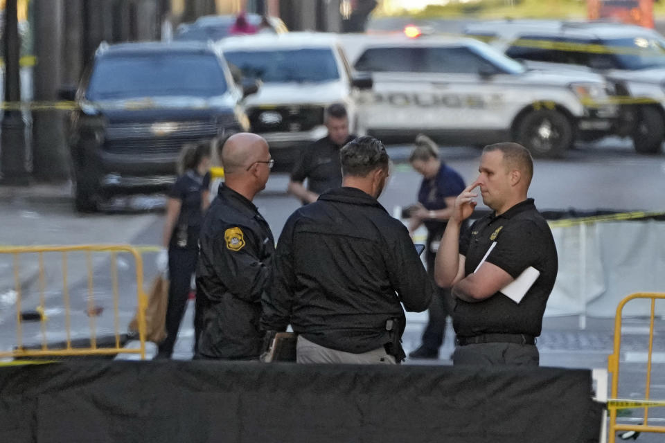 FILE -Tampa police officers stand in the street in the Ybor City section of Tampa, Fla., after a shooting Sunday, Oct. 29, 2023. A fight between two groups turned deadly in a shooting during Halloween festivities. A fight between two groups turned deadly in a shooting during Halloween festivities. A 14-year-old boy has been charged with second-degree murder in the death of a 20-year-old during a Halloween weekend mass shooting that left two people dead and 16 injured in Tampa's Ybor City, officials said, Wednesday, Dec. 6, 2023. (AP Photo/Chris O'Meara, File)