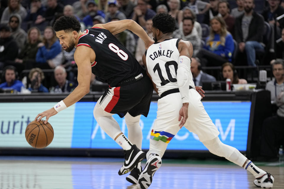 Portland Trail Blazers guard Skylar Mays (8) handles the ball while defended by Minnesota Timberwolves guard Mike Conley (10) during the second half of an NBA basketball game, Sunday, April 2, 2023, in Minneapolis. (AP Photo/Abbie Parr)